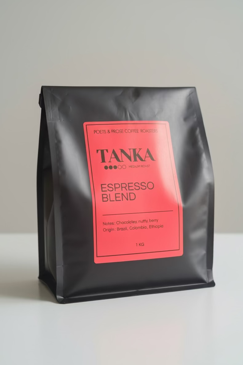Black coffee bag with a red label featuring 'TANKA Espresso Blend' on a white background
