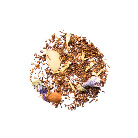 Spice mix including cinnamon, cloves, and cardamom on a white background