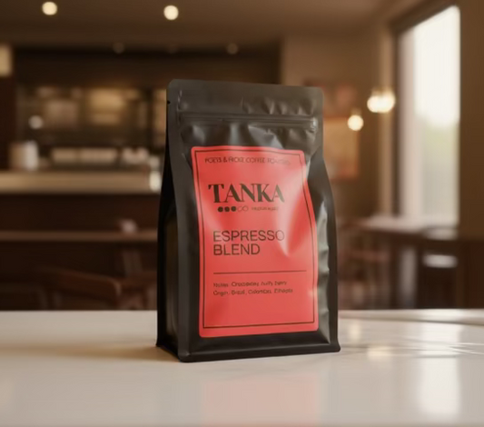 TANKA Espresso Blend coffee package on a table with a blurred cafe background