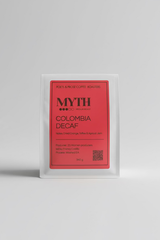 Coffee package labeled 'Myth Colombia Decaf' by Poets & Prose Coffee Roasters on a blurred background.