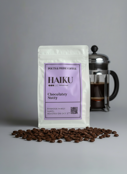 Coffee package labeled 'Haiku' with chocolate and coffee beans on a gray background