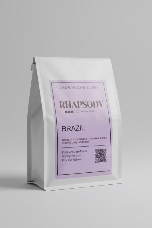 Rhapsody coffee bag with purple label on a gray background