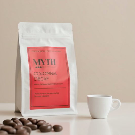 Coffee bag labeled 'MYTH Colombia Decaf' with a white cup and coffee beans on a beige background