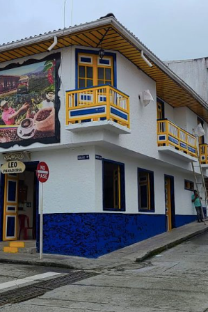Colorful building facade with mural and street sign in a town setting