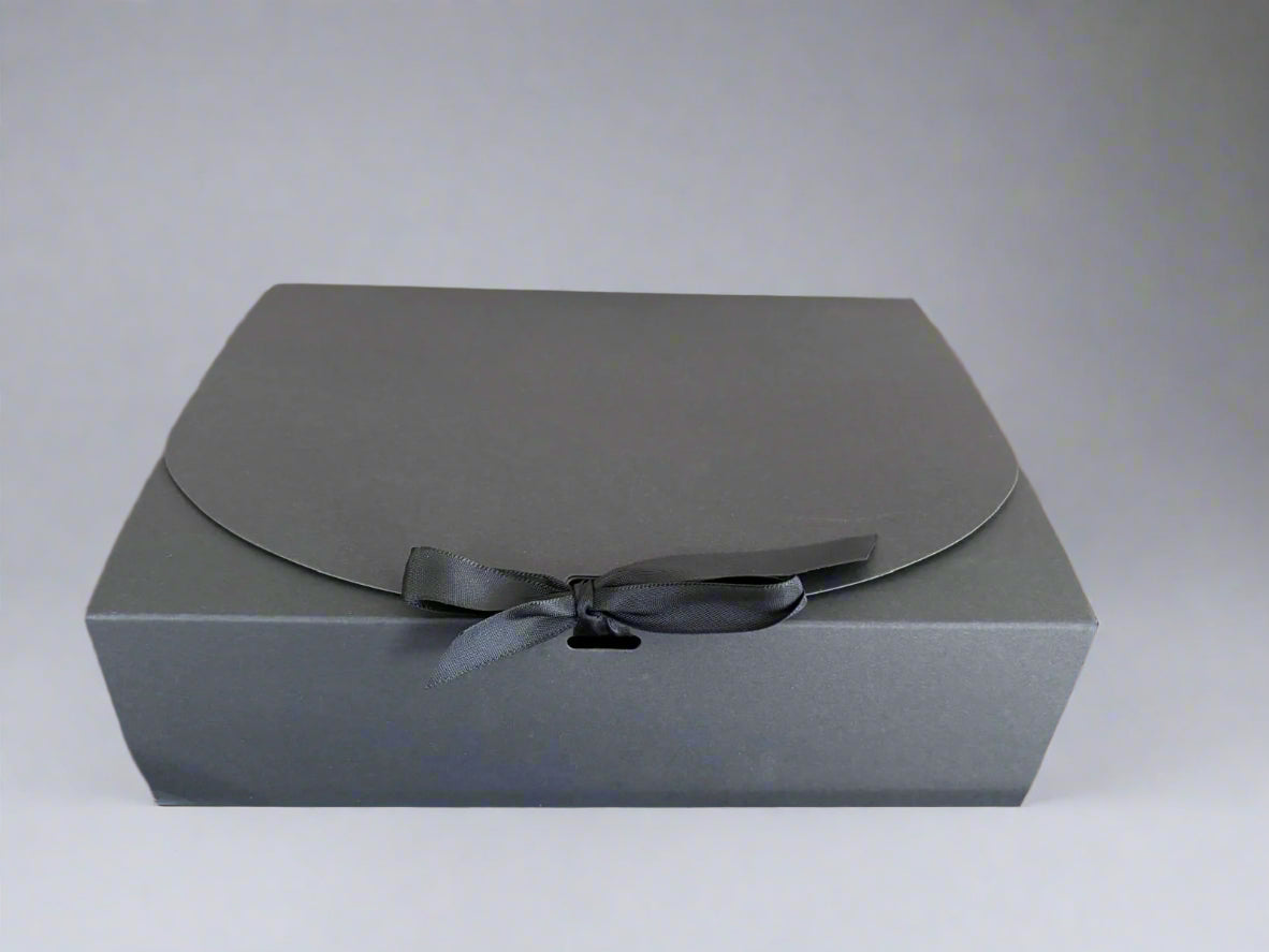 Gray gift box with a black ribbon on a light gray background